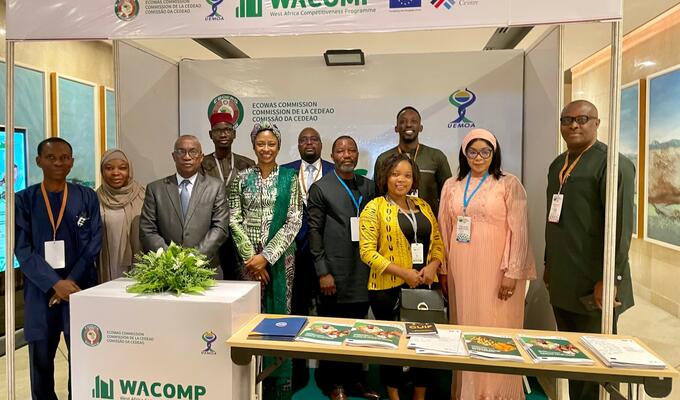 Group of West African business leaders pose inside investment promotion booth