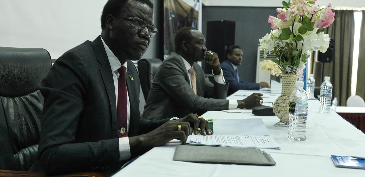 South Sudanese government official speaks at conference while seated at table